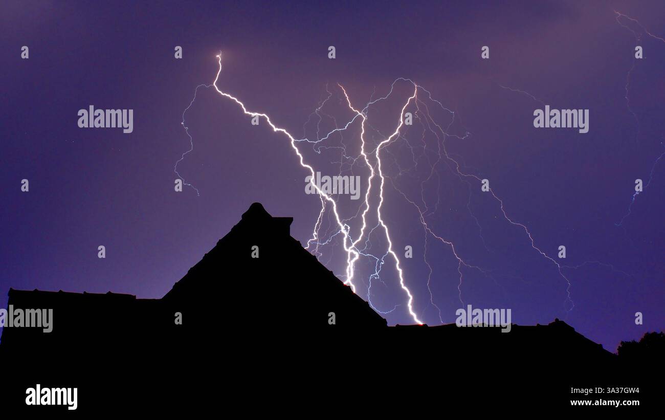 Blitze, Gewitter, fulmine, tempesta estiva proprio fuori dal mio lucernario con vista sulle case Foto Stock