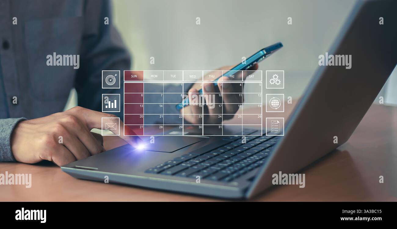 L'uomo d'affari usa il dito indice per impostare l'agenda sul calendario come concetto di pianificazione degli appuntamenti. Foto Stock