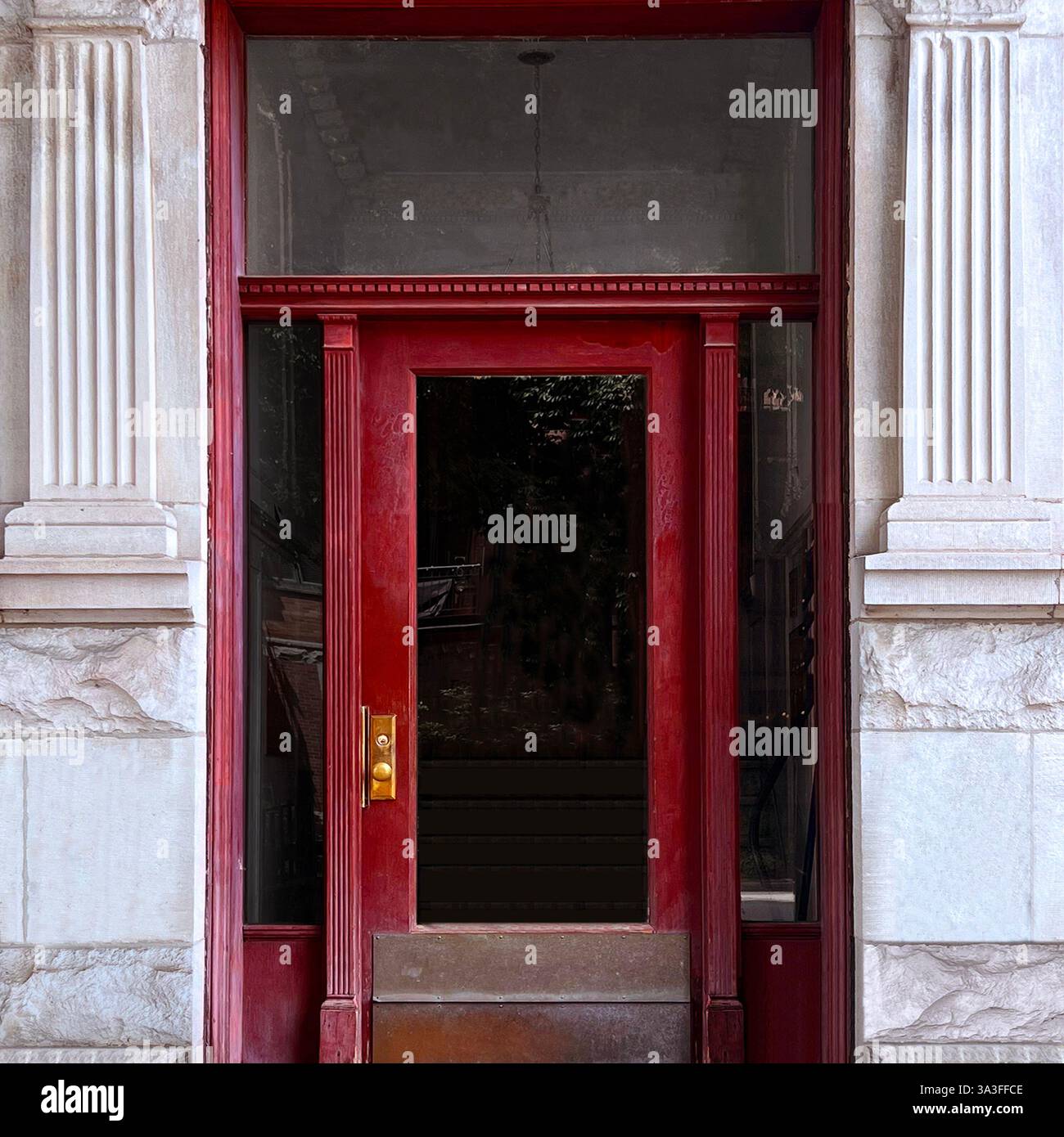 Un'audace entrata rossa con colonne neoclassiche e intricati dettagli architettonici che catturano l'eleganza storica di Chicago. Foto Stock