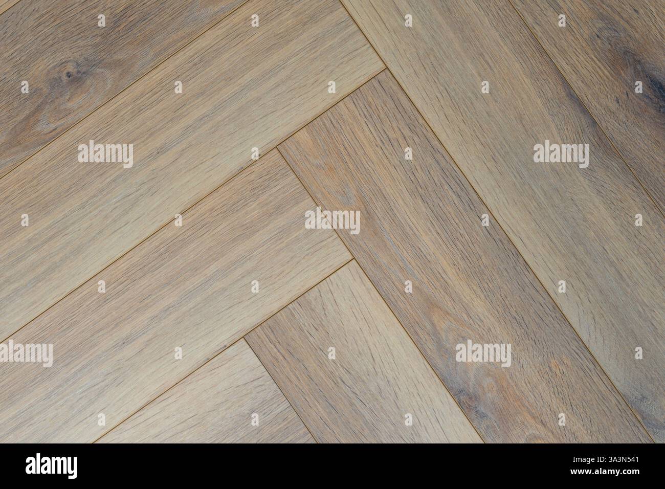 Squisita texture a spina di pesce in calde tonalità di grigio, che creano intimità ed eleganza negli interni. Foto Stock