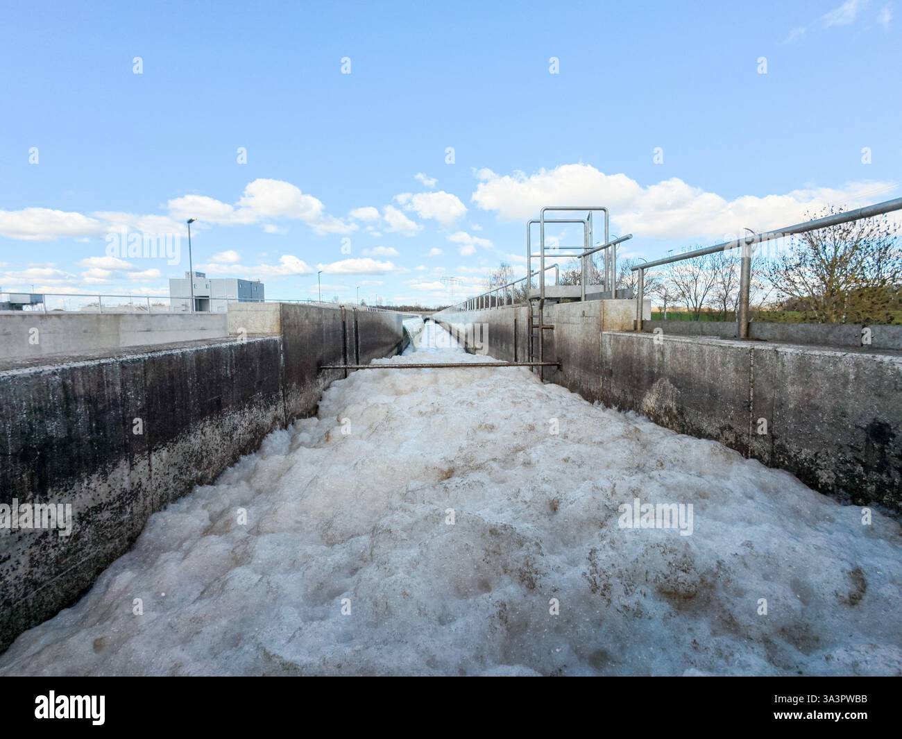 17 marzo 2025, Berlino, Schönefeld: L'acqua fluisce nei chiarificatori dell'impianto di depurazione di Waßmannsdorf. L'ampliamento dell'impianto di depurazione di Waßmannsdorf è stato completato. L'impianto di trattamento delle acque reflue comprende impianti per la rimozione dell'azoto e del fosforo ed è stato costruito anche un grande serbatoio di acqua mista. Foto: Carsten Koall/dpa Foto Stock