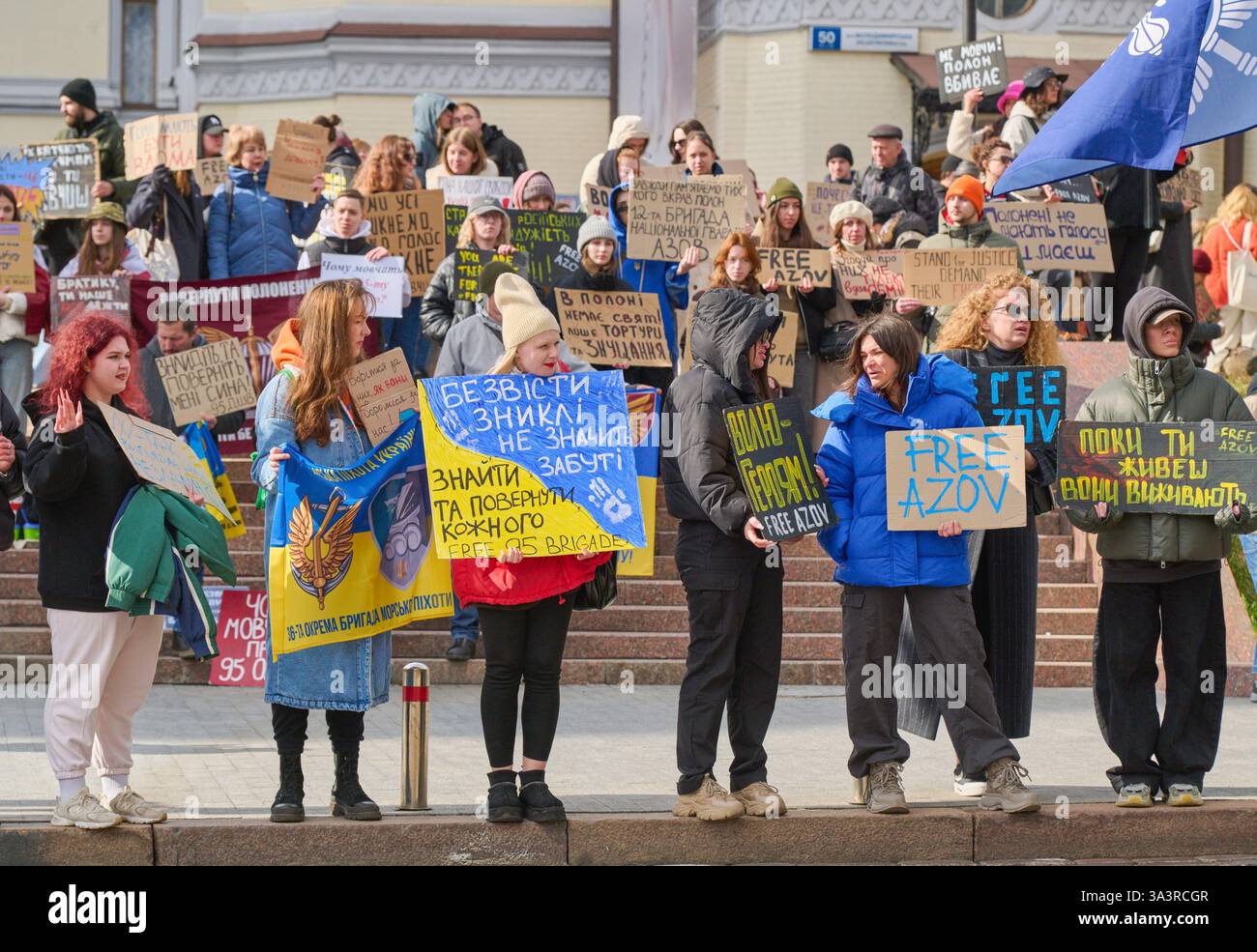 Kiev, Ucraina - 16 marzo 2025 persone si riuniscono in via Volodumirska presso l'Opera Nazionale Ucraina tenendo striscioni con slogan come Free Azov e. Foto Stock
