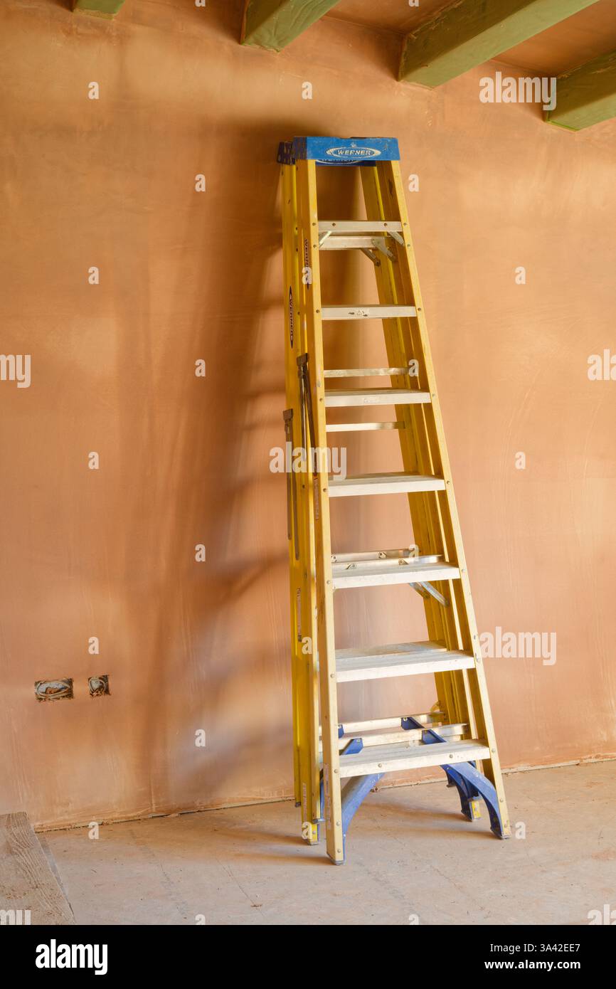 Una camera intonacata di recente con scala a cavalletto. Lavori di costruzione rifiniti con una superficie liscia e piatta di intonaco sottile. Una grande abilità. Foto Stock