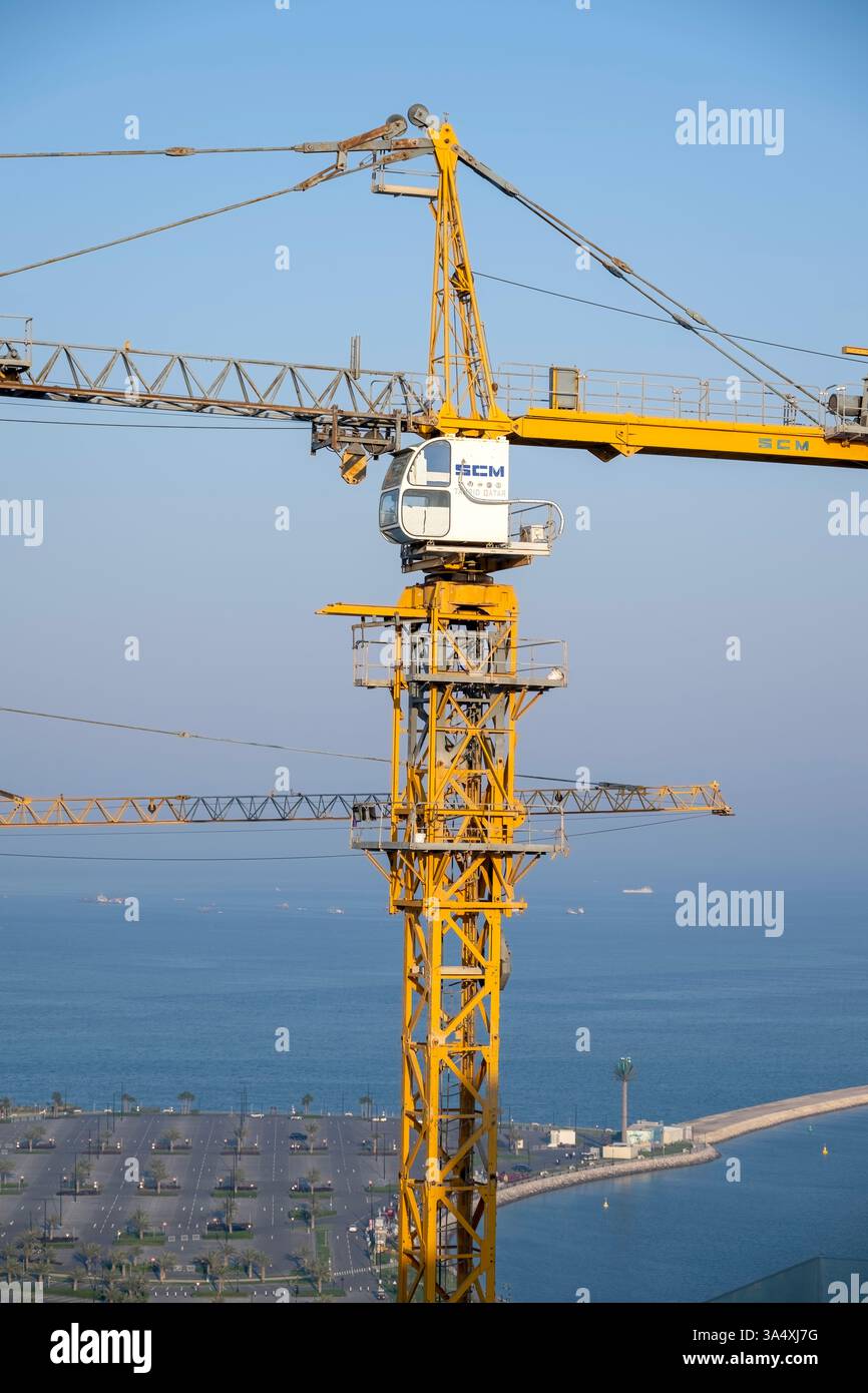 La gru a torre si affaccia dall'alto edificio. Foto Stock