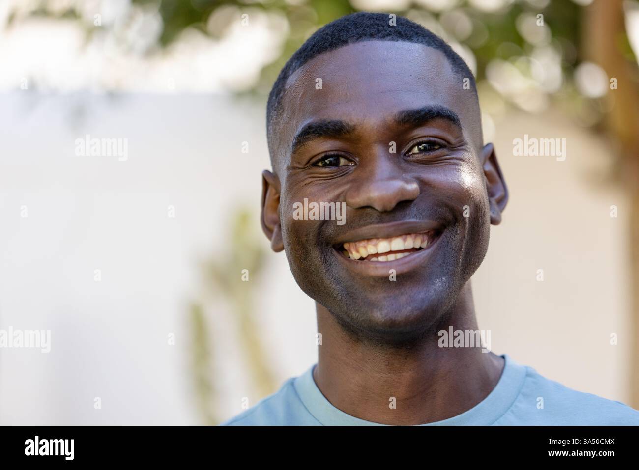 Uomo sorridente che si gode una vacanza all'aperto, si sente felice e rilassato nella natura Foto Stock