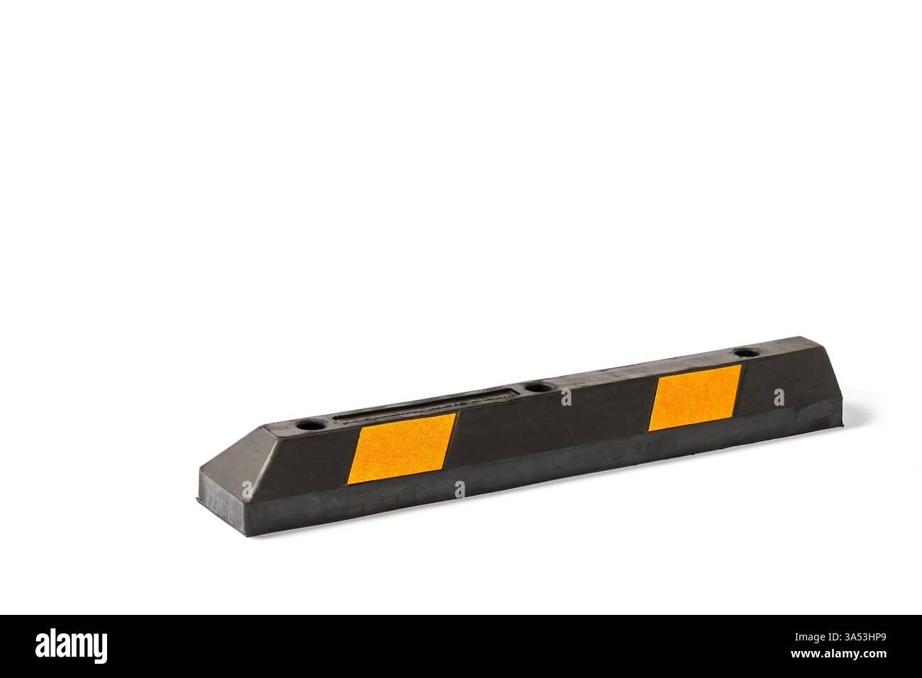 Un resistente fermo in gomma con strisce riflettenti gialle brillanti per una maggiore visibilità e sicurezza nelle aree di parcheggio e nelle vialetti. Foto Stock