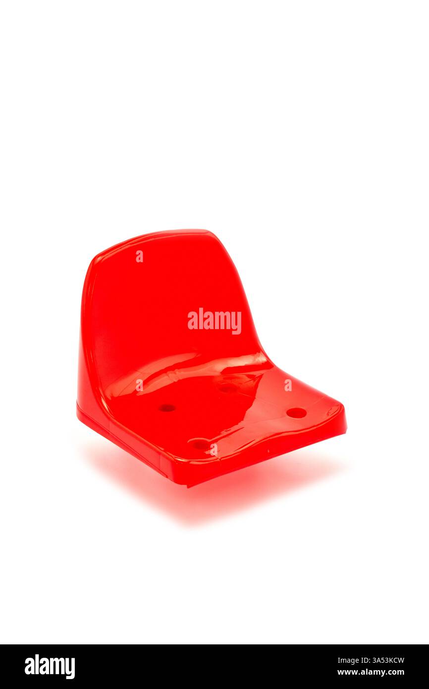 Sedia in plastica rossa brillante adatta per aree gioco per bambini, ideale per l'uso interno o esterno, leggera, resistente e facile da pulire, perfetta per la casa Foto Stock