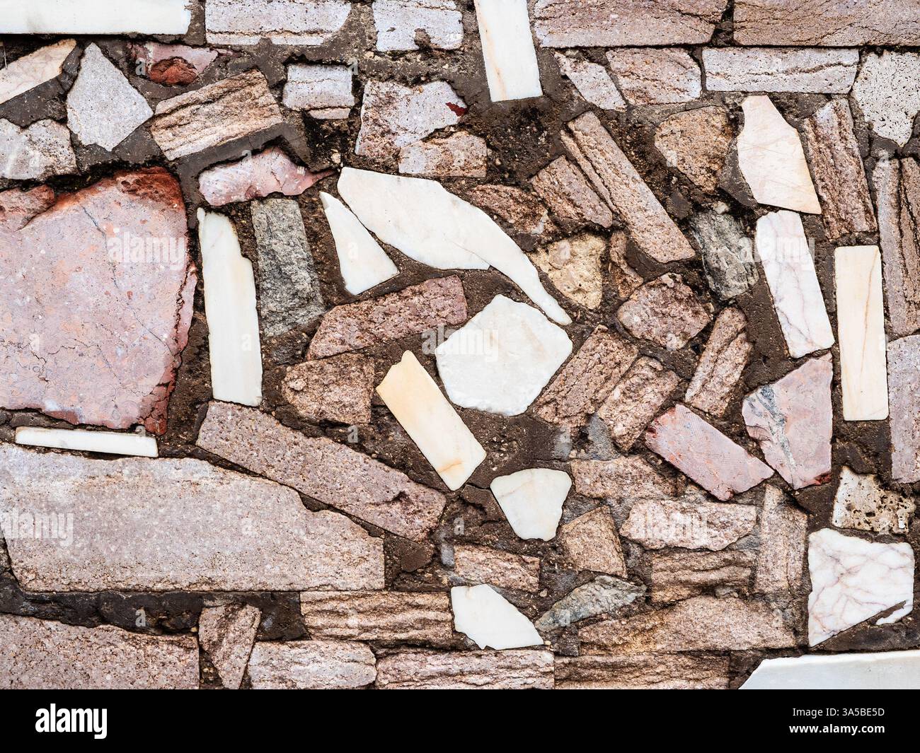 Muro di tufo rosa armeno e pietre di marmo bianco nella città di Erevan Foto Stock