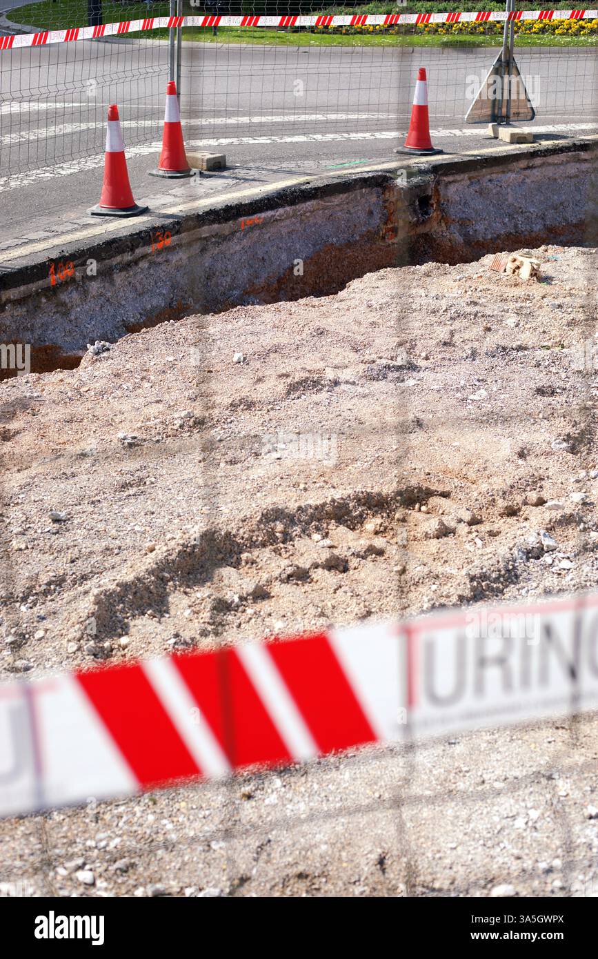 Oviedo, Spagna - 03.10.2025: Cantiere con cautela coni e nastro di sicurezza che bloccano un'area di scavo stradale Foto Stock