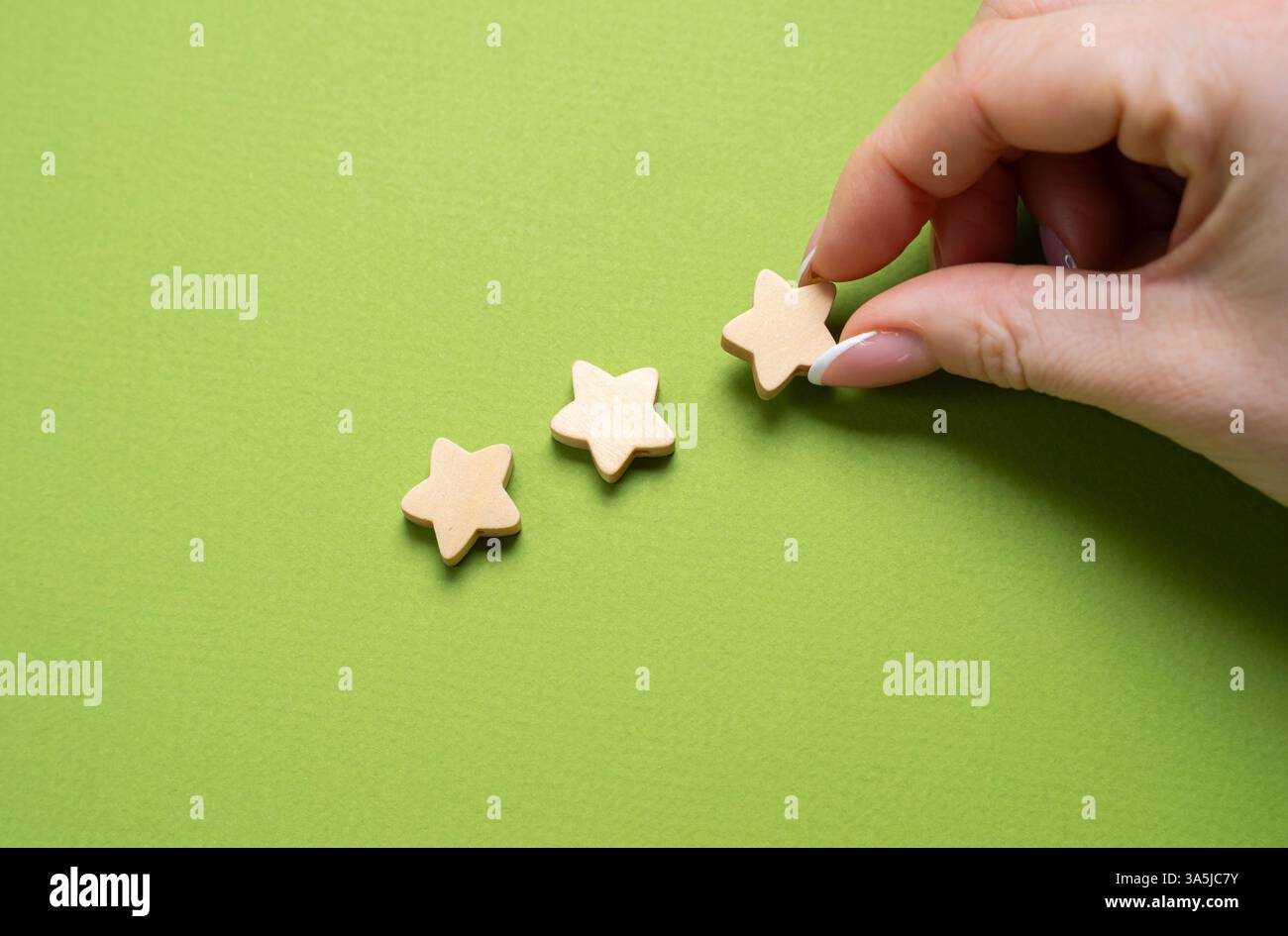 Assegna una valutazione di tre stelle. Recensioni online. Qualità superiore, servizio eccezionale, prestazioni eccezionali. Foto Stock