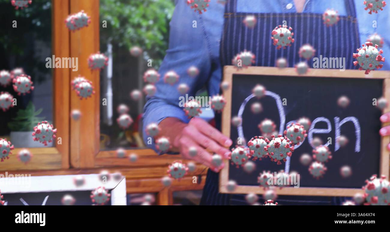 Proprietario di una piccola impresa con un cartello aperto con particelle di virus che fluttuano intorno Foto Stock