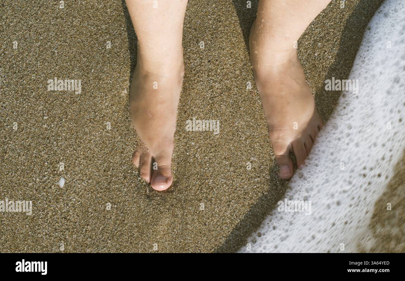 Due gambe in onde del mare. Suny giorno Foto Stock