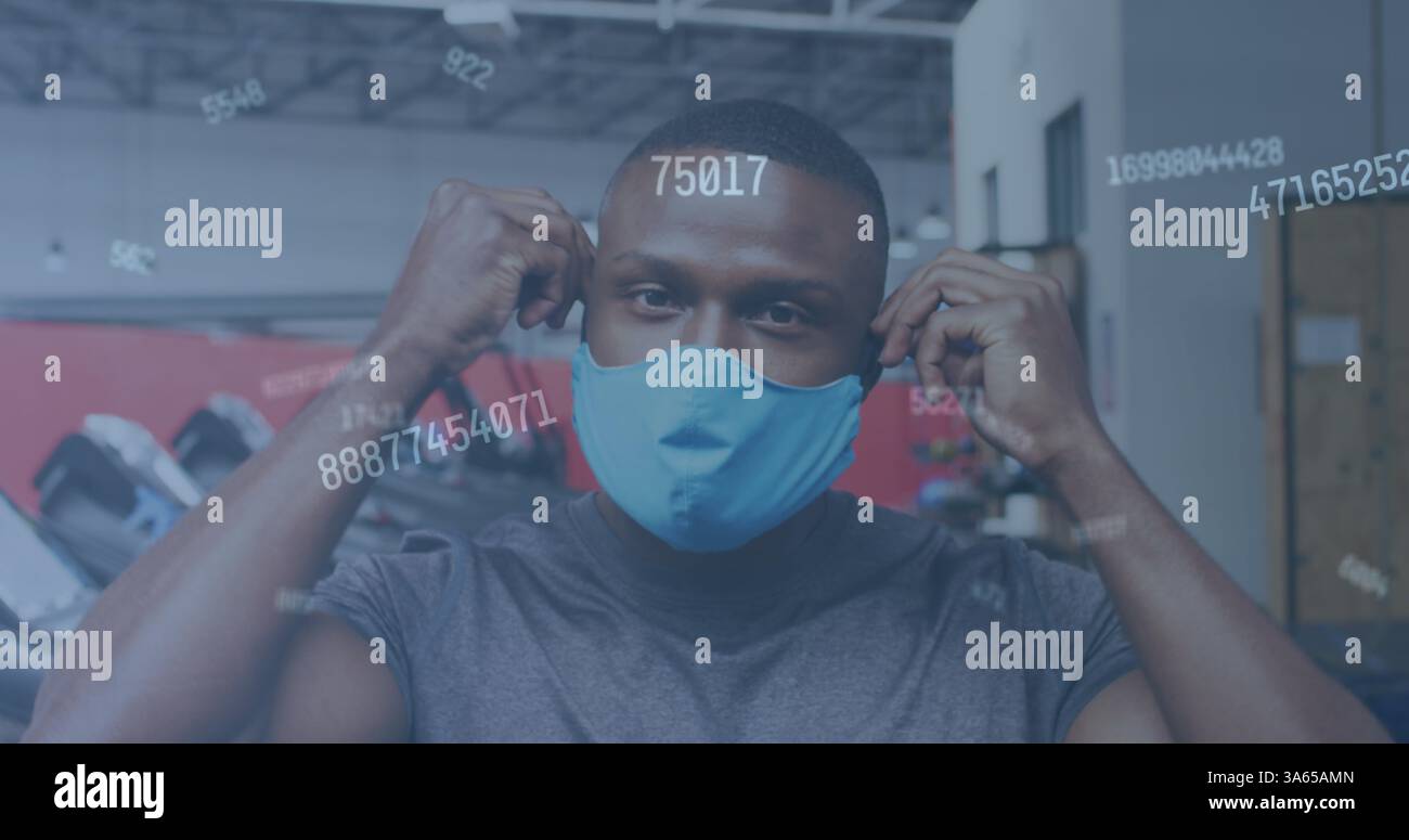 Immagine di numeri che cambiano l'uomo che mette la maschera in palestra Foto Stock