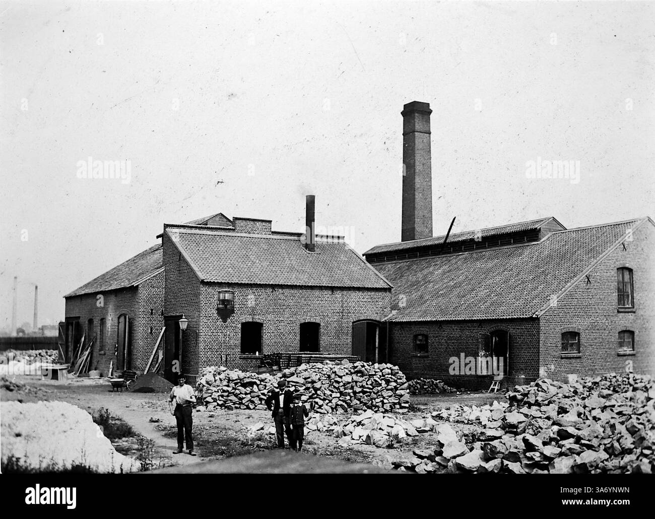 Ida Werk, Ganister Brick lavora a Linn, un quartiere storico della città di Krefeld, situato nello stato della Renania settentrionale-Vestfalia, Germania. Questa immagine include gli edifici che componevano le opere, uno con un camino alto. Tre persone sono in primo piano. Da una raccolta di fotografie tratte da un tour europeo di famiglia che si è svolto nel 1899. Le fotografie originali erano di circa 3 ½ x 2 ½ pollici e presentano un'interessante vista dei costumi, delle mode e della storia sociale del tardo periodo vittoriano. Foto Stock