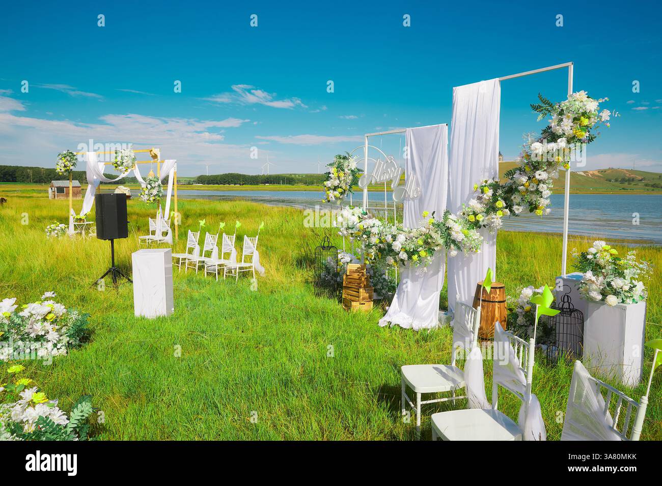 Sala per matrimoni fronte lago con tenda bianca e decorazioni floreali Foto Stock