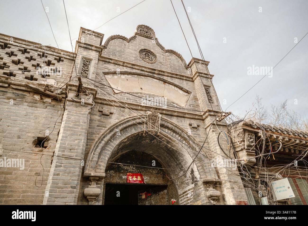 Ingresso Cinese con colonne di pietra e porta di legno Foto Stock