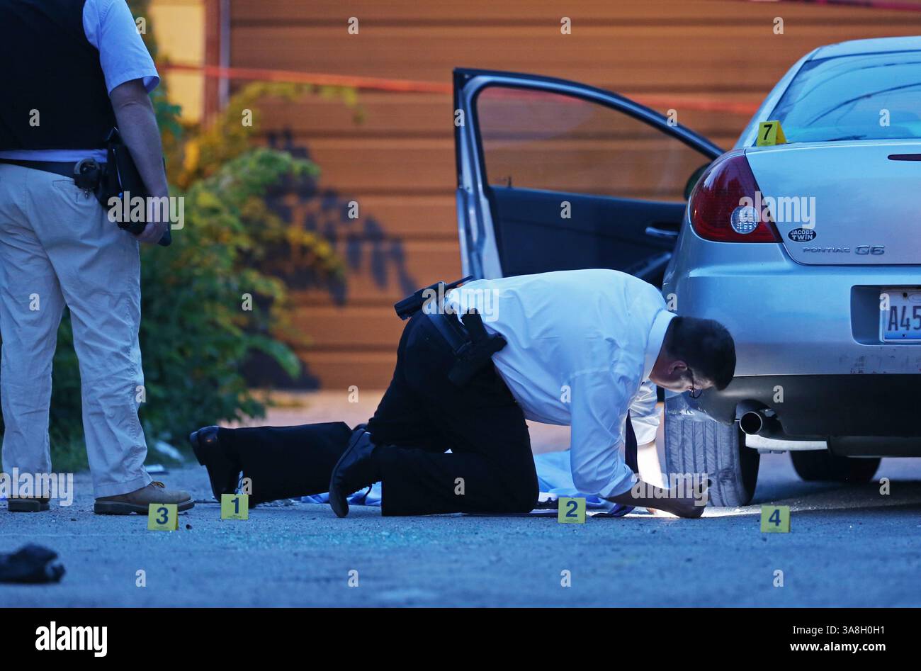 10 settembre 2017 - Chicago, Illinois, USA - Un detective della polizia di Chicago indaga sulla scena in cui un uomo defunto, 30 anni, si trova in un vicolo ad ovest del blocco 0-100 di North Laramie Avenue sabato 19 luglio 2014, a Chicago. (Immagine di credito: © John J. Kim/TNS via ZUMA Wire) Foto Stock