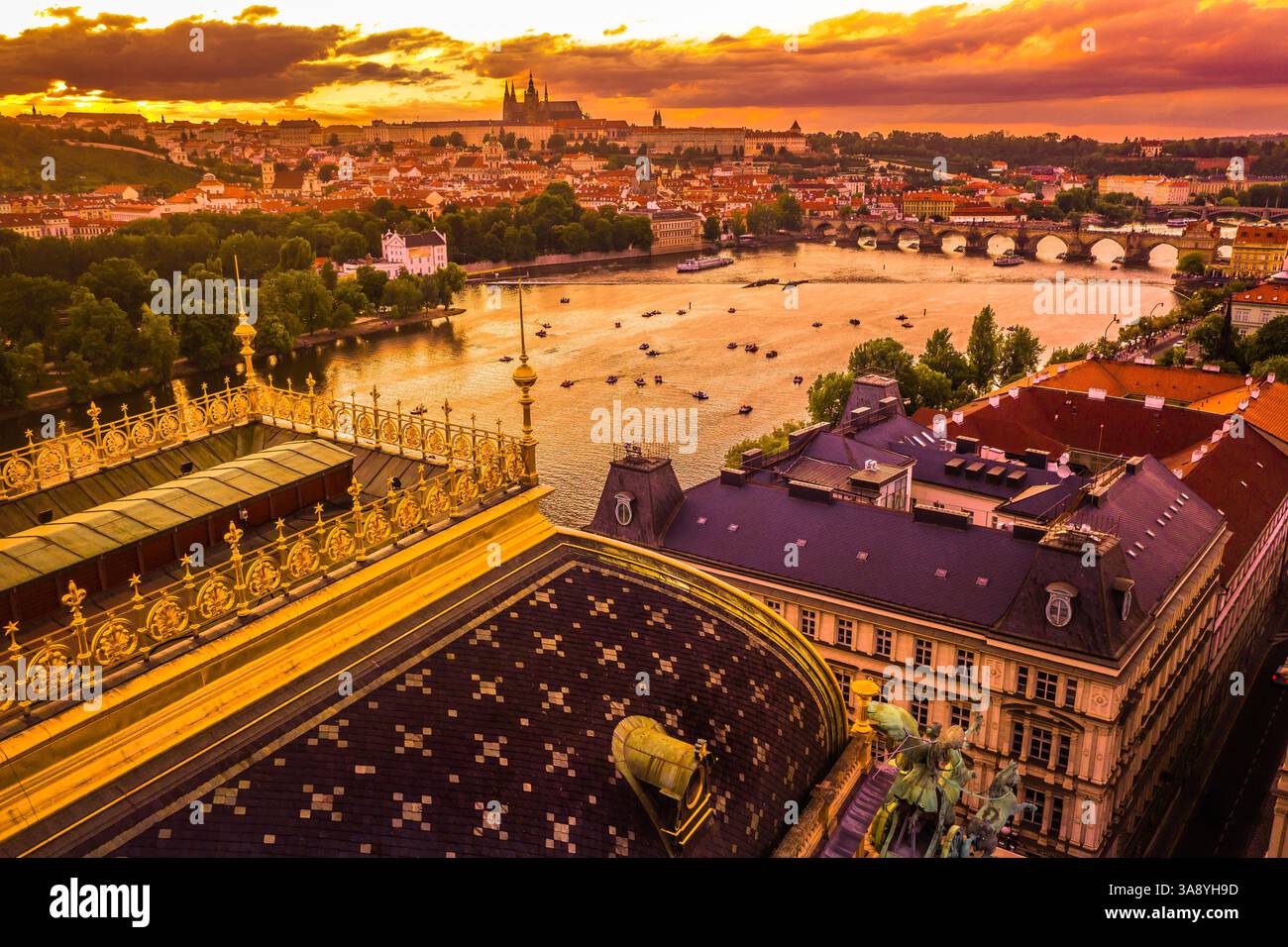 Uno splendido panorama aereo dei tetti storici di Praga, che offre una vista mozzafiato degli edifici con piastrelle rosse della città e delle guglie iconiche Foto Stock Uno splendido panorama aereo dei tetti storici di Praga, che offre una vista mozzafiato degli edifici con piastrelle rosse della città e delle guglie iconiche Foto Stock