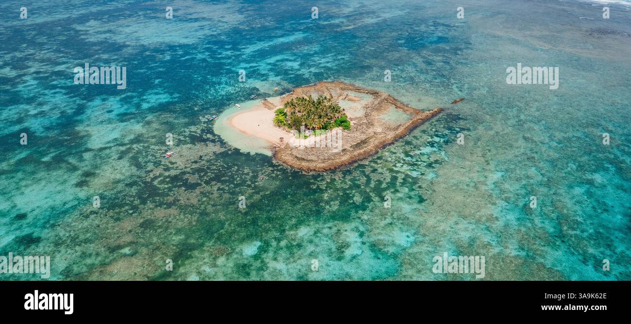 Vista aerea dell'isola di Guyam, Siargao, Una piccola e bellissima isola circondata da acque cristalline, spiagge di sabbia bianca e lussureggianti palme Foto Stock