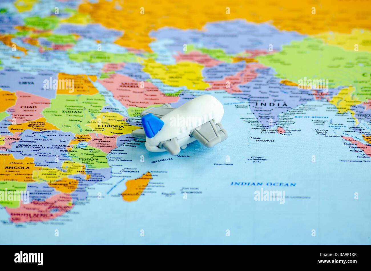 Piccolo aereo posizionato su una mappa del mondo che rappresenta il viaggio o l'esplorazione globale. Foto Stock