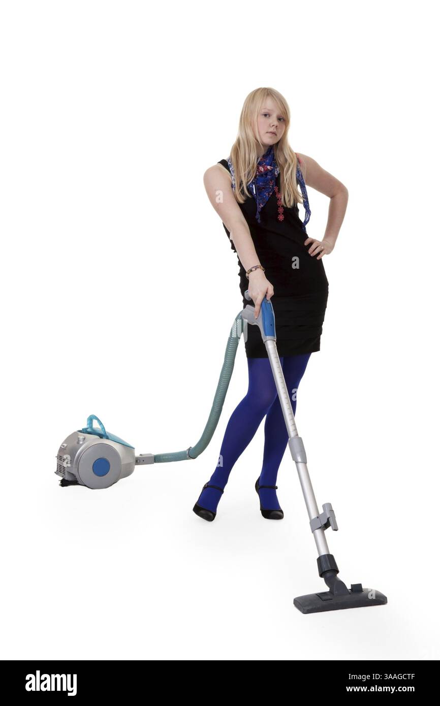 La ragazza in blu collant con un aspirapolvere Foto Stock