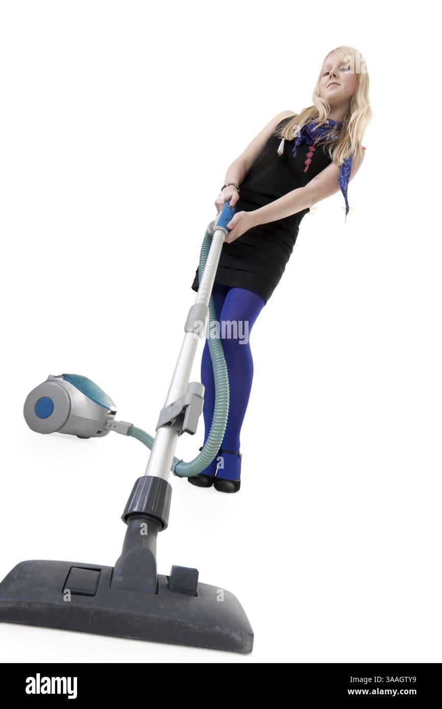 La ragazza in blu collant con un aspirapolvere Foto Stock