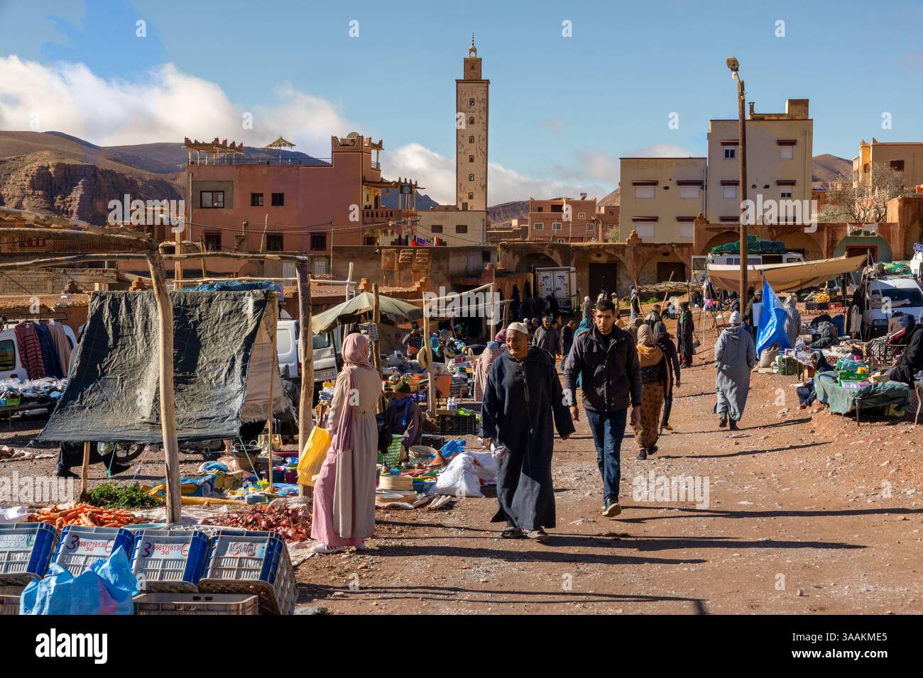 Tamellalt, Marocco - 19 febbraio 2025: Mercato con sgabelli e moschea sullo sfondo Foto Stock