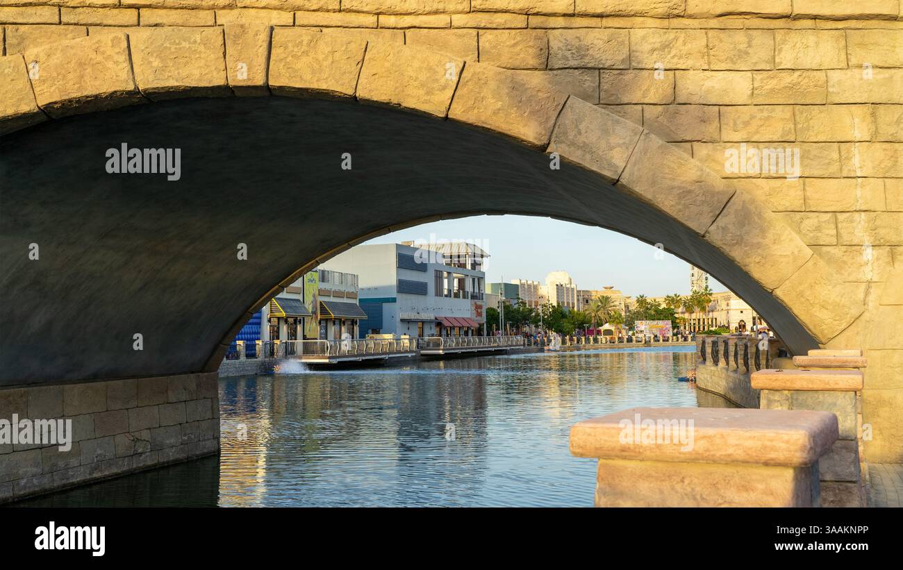 Canale artificiale o baia o stagno e ponte decorativo nell'area di Riverland vicino ai parchi di divertimento, Dubai, Emirati Arabi Uniti. Foto Stock