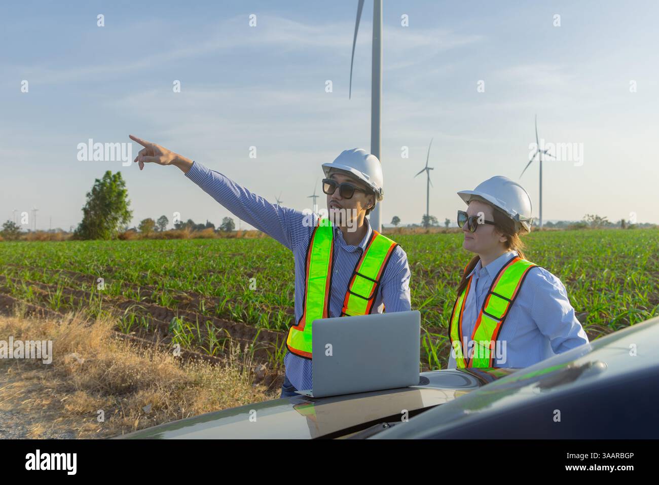 Il team di ingegneri con Architect Field Work insieme progettano la costruzione di turbine eoliche per l'analisi del territorio nelle campagne agricole Foto Stock Il team di ingegneri con Architect Field Work insieme progettano la costruzione di turbine eoliche per l'analisi del territorio nelle campagne agricole Foto Stock