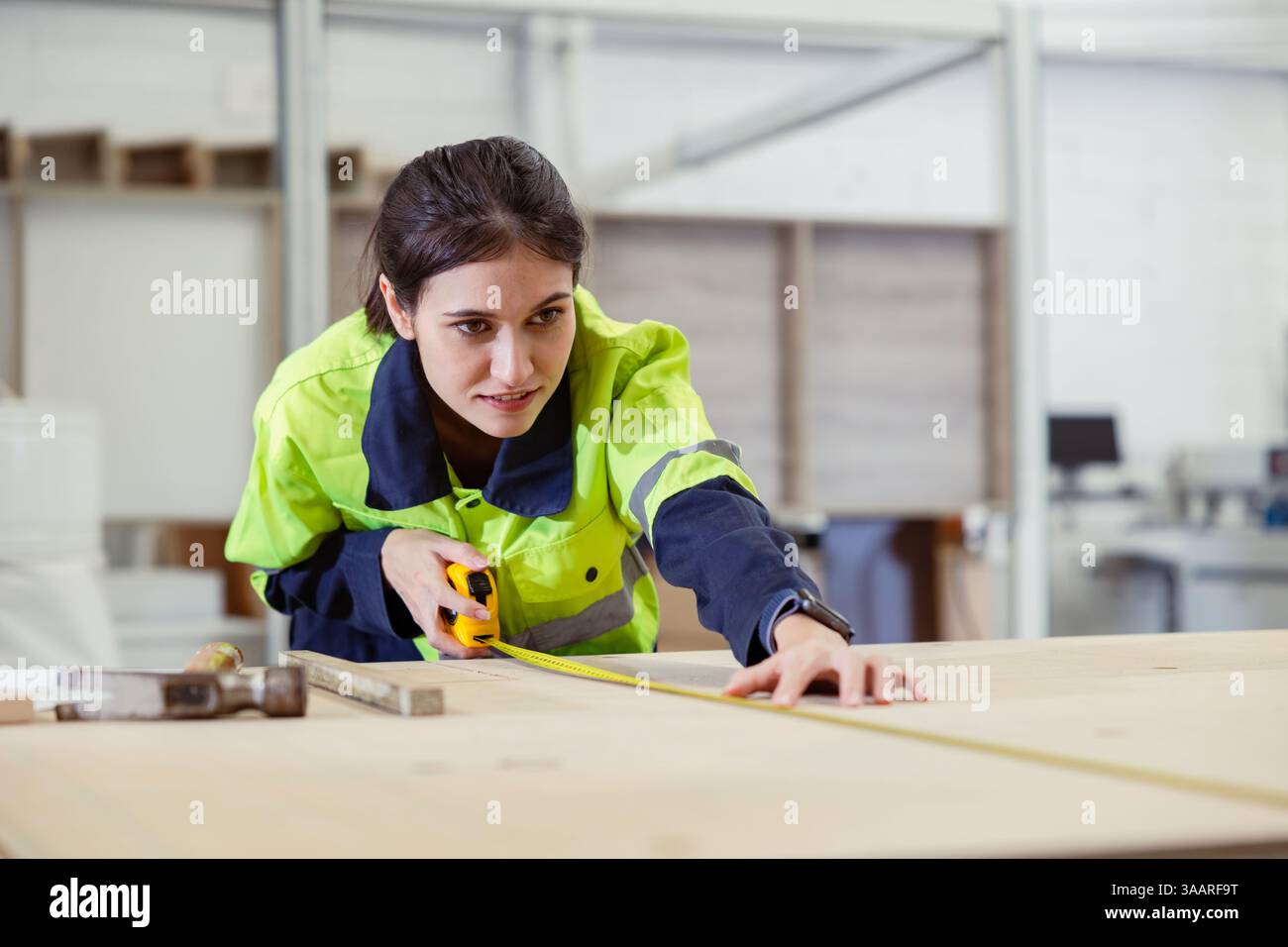 Le donne professionali lavoratrici del personale amano lavorare utilizzando il metro metro a nastro compensato prodotto per mobili in legno in fabbrica con tuta di sicurezza Foto Stock Le donne professionali lavoratrici del personale amano lavorare utilizzando il metro metro a nastro compensato prodotto per mobili in legno in fabbrica con tuta di sicurezza Foto Stock