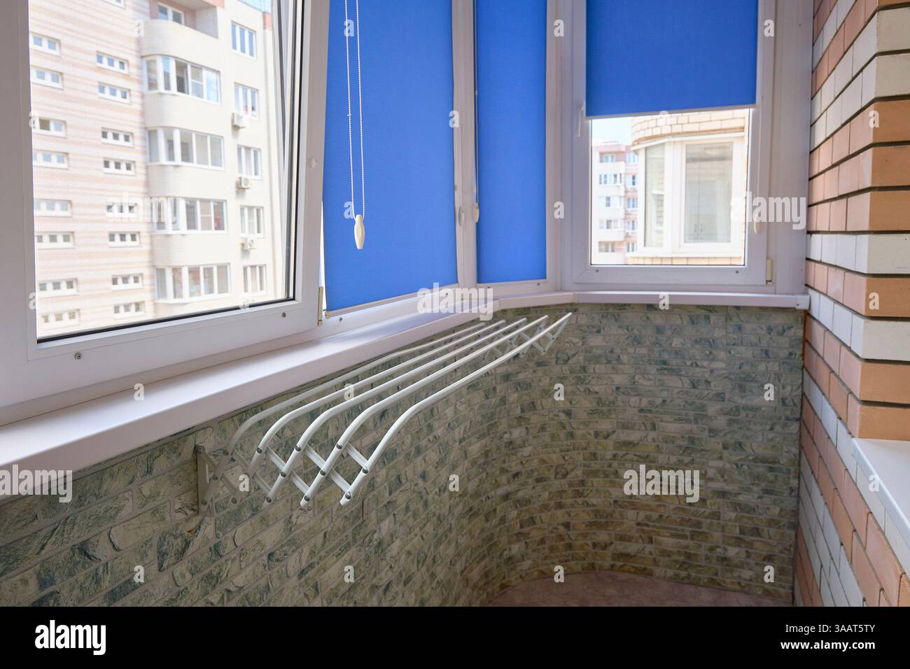 Accogliente balcone con vista, un paradiso illuminato dal sole per momenti tranquilli, con vita urbana e semplici comfort. Foto Stock