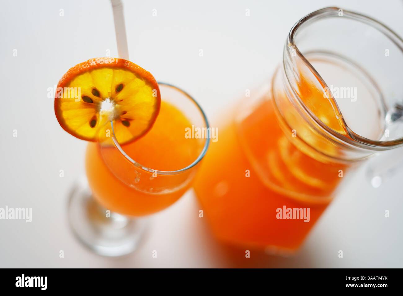 Caraffa in vetro e bicchiere riempito con succo d'arancia. Fotografia d'archivio Foto Stock