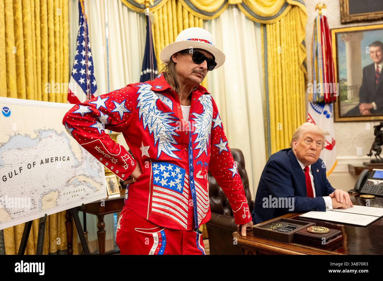 Washington, Stati Uniti. 31 marzo 2025. U. Il presidente Donald Trump firma un ordine esecutivo che vieta lo scalpore dei biglietti sfruttativi mentre il musicista Kid Rock, a sinistra, guarda all'ufficio ovale della Casa Bianca, 31 marzo 2025 a Washington, DC Credit: Molly Riley/White House Photo/Alamy Live News Foto Stock