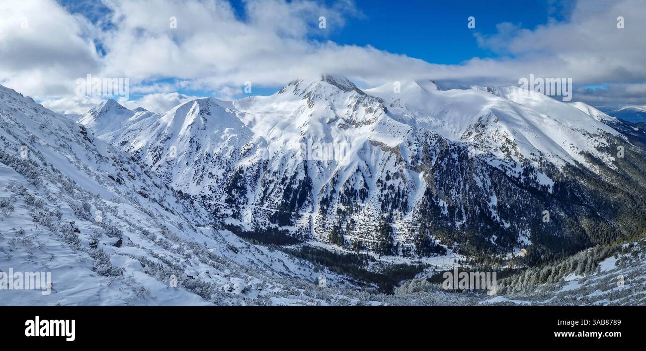 Vista panoramica aerea sulle montagne Pirin con cime rocciose ricoperte di neve. Vista invernale della stazione sciistica di Bansko in Bulgaria - Immagine stock catturata con smartphone