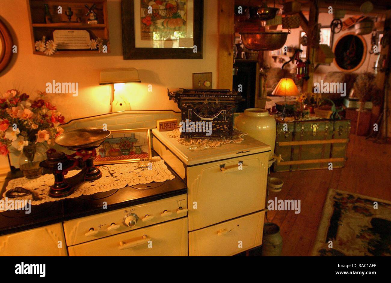 29 maggio 2002 - Woodland, California, Stati Uniti - Mark Reiff (CQ), nativo di Woodland, 53 anni, ha trasformato la sua casa in stile ranch in un quartiere ombreggiato nel centro di Woodland in una baracca di campagna (così la chiama Sylva) con una stazione di servizio a due pompe e un garage. Ha passato gli ultimi tre anni a ristrutturare la casa. Qui sotto il caldo bagliore di una lampada è presente un'antica stufa che Reiff usa come scrivania, riponendo al suo interno i suoi documenti. L'interno della casa è ricco di fascino rurale a ogni angolo. (Immagine di credito: © Chris Crewell/Sacramento Bee/ZUMA Press) RESTRIZIONI: * Tabloids USA Rights OUT * Foto Stock