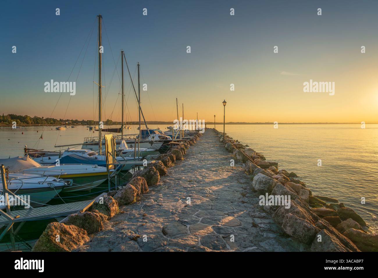 Lago di Garda, barche nel porto turistico e molo, vista del tramonto da Pacengo, Lazise, provincia di Verona, regione Veneto, Italia, Europa Foto Stock