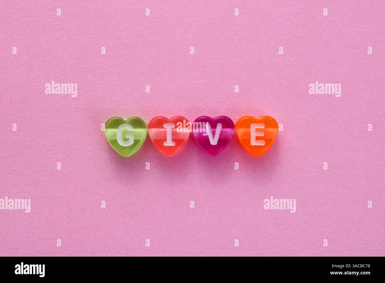 Dare, parola formata con cuori colorati Foto Stock