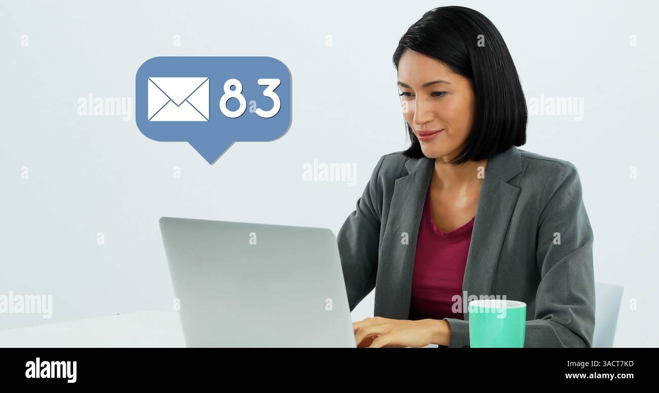 Donna professionista che controlla le e-mail sul computer portatile con una tazza di caffè sulla scrivania Foto Stock