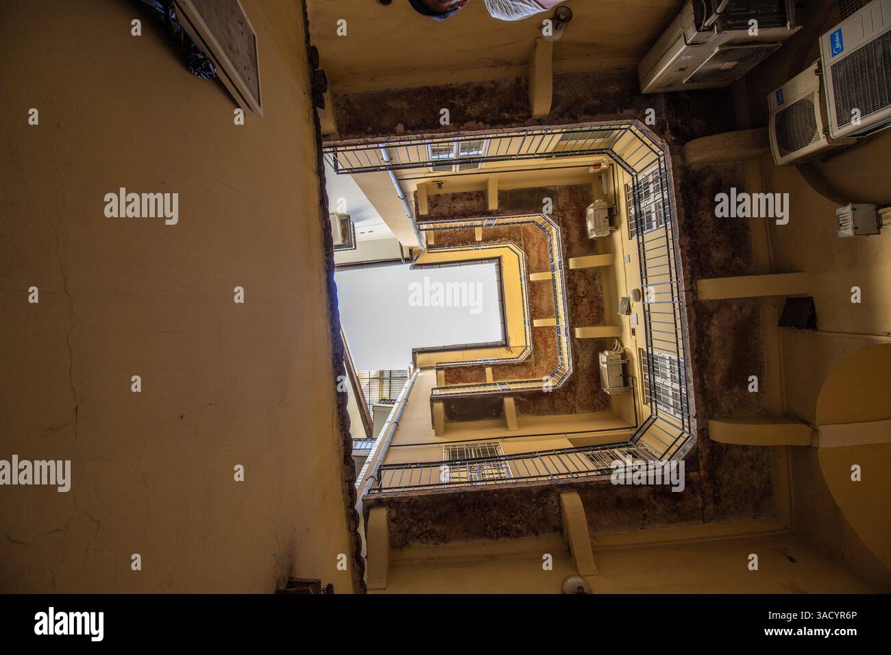 Vista verso l'alto, cortile interno di un blocco di case, tipico di questo tipo di edificio nella storica città di Budapest, Ungheria Foto Stock