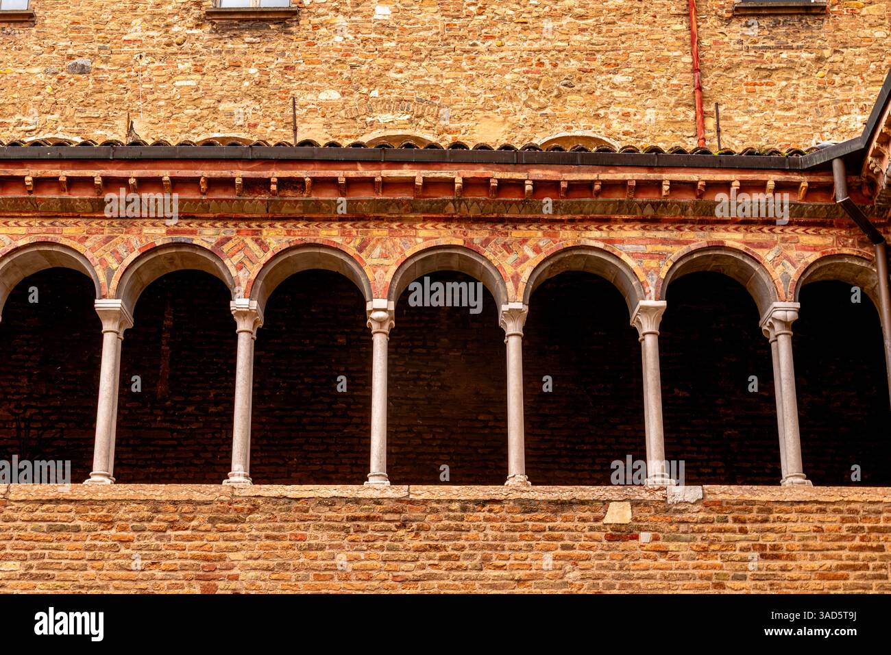 Archi nel cortile interno della Basilica Santo Stefano, un complesso di edifici religiosi nella città di Bologna Foto Stock