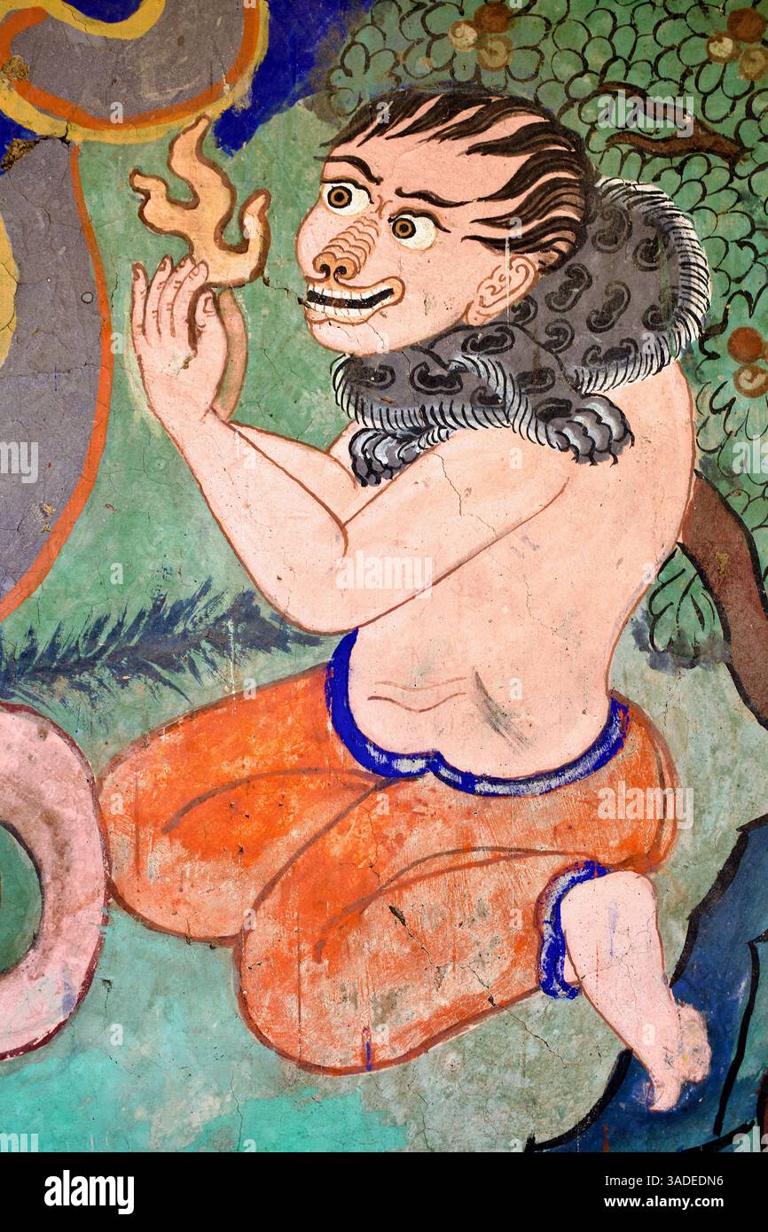 Spirito sorridente che tiene una fiamma sotto un albero fiorito nel murale del monastero di Thiksey, Ladakh. Foto Stock