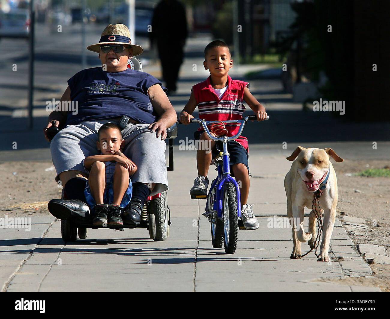 Casey Christie / The Californian. Paul Yasania porta i suoi nipoti, Johnny Garcia, e Sergio Sanchez al negozio venerdì su Chester Avenue il cane non apparteneva a loro, ha iniziato a camminare con loro durante la loro passeggiata mattutina. (Immagine di credito: The Bakersfield Californian/ZUMAPRESS.com) Foto Stock