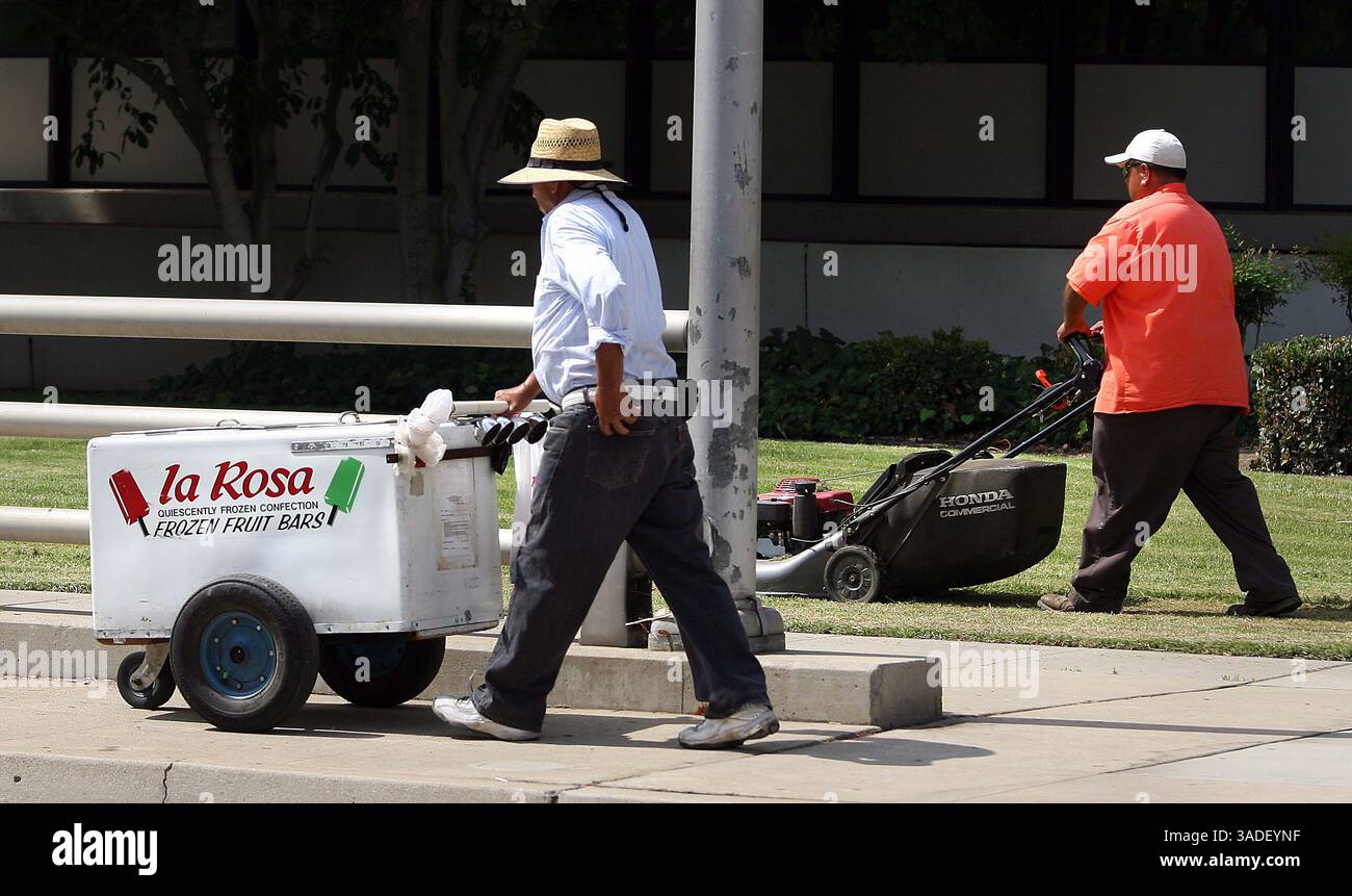 Casey Christie / The Californian. Un bar di frutta surgelata a la Rosa e un operaio della città di Bakersfield fanno entrambi il loro lavoro lungo Chester Avenue vicino a Truxtun Avenue Tuesday nel centro città. (Immagine di credito: The Bakersfield Californian/ZUMAPRESS.com) Foto Stock
