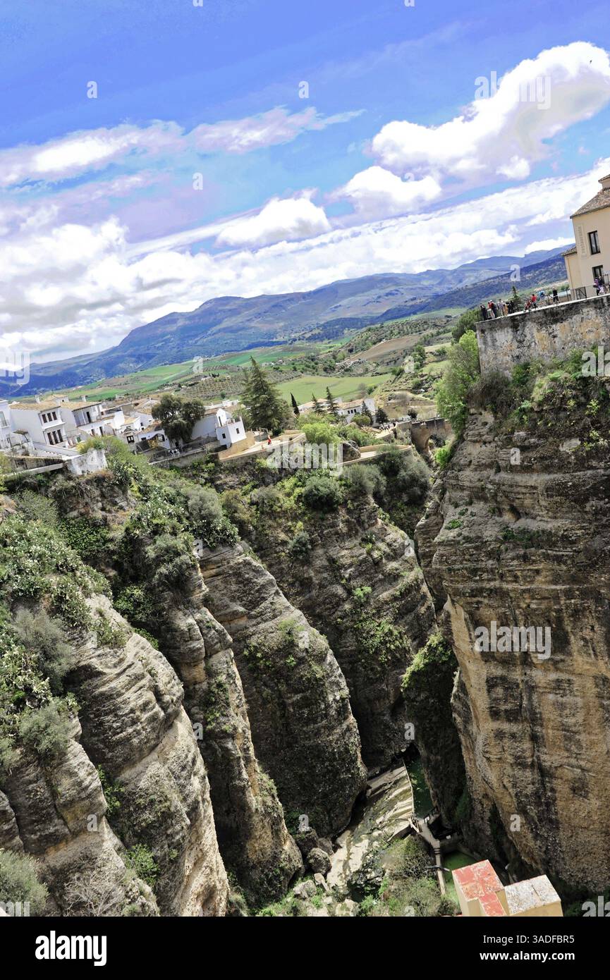 Vista dal ponte di Puente Nuevo, dalla gola di El Tajo, da Ronda, dalla provincia di Malaga, dall'Andalusia, un'immagine dettagliata di rocce e gola con case e paesaggi verdi Foto Stock