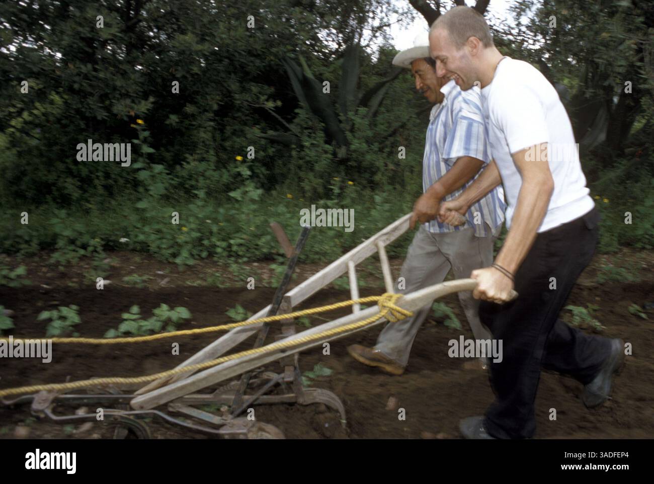 Il cantante "Coldplay" CHRIS MARTIN riceve alcuni consigli dal contadino messicano ALEJANDRINO FLORES in un campo di mais fuori dal villaggio di Santa Isabel Tepetzala, Puebla, Messico. "Coldplay" ha visitato i coltivatori di mais messicani per sostenere la campagna "Make Trade Fair" della ONG britannica Oxfam. La campagna chiede ai governi di ridurre le sovvenzioni agli agricoltori dei paesi ricchi ed eliminare il dumping dei prodotti agricoli. (Immagine di credito: Keith Dannemiller/ZUMAPRESS.com) Foto Stock