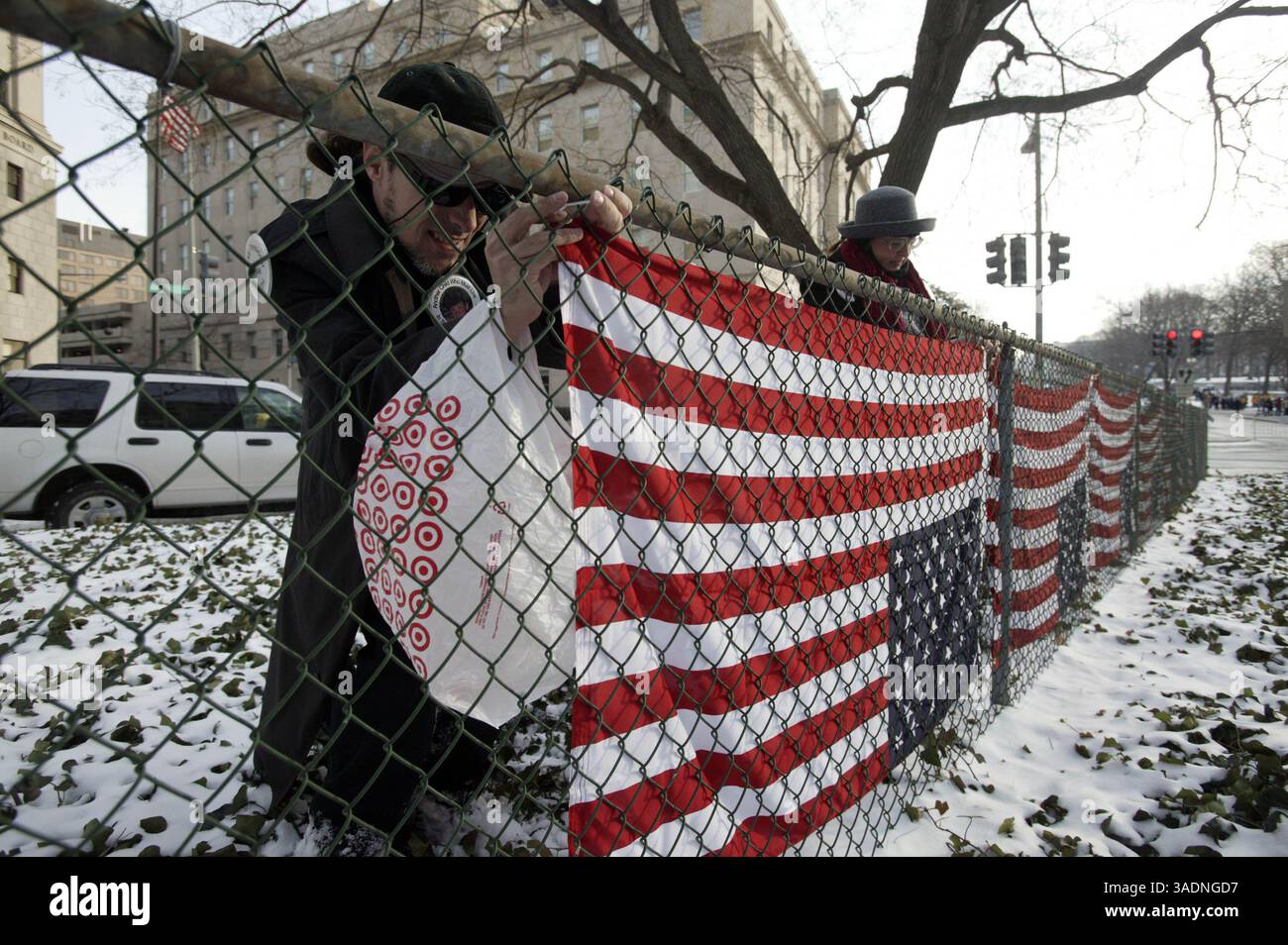 20 gennaio 2005; Washington, DC, USA; i manifestanti indipendenti SCOTT KEMPER e REGAN, entrambi di Los Angeles, appendono le bandiere capovolte intorno all'intersezione tra NW Indiana e NW 1st Street prima dell'inaugurazione. (Immagine di credito: James W. Prichard/ZUMAPRESS.com) Foto Stock