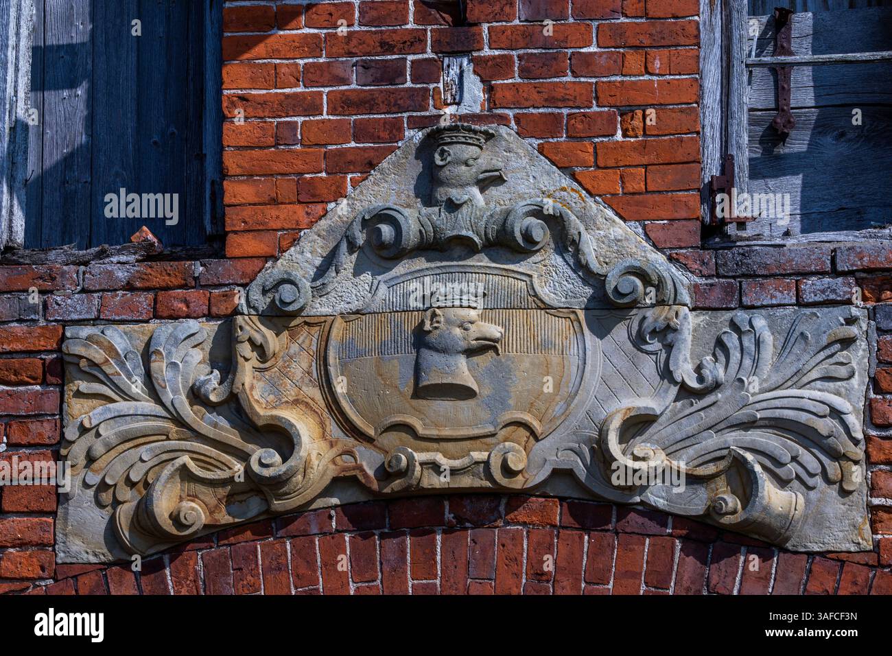 Dassow, Germania. 2 aprile 2025. Uno stemma su un muro esterno del castello di Johannstorf. Dopo un incendio il 1° marzo 2025, rimane solo la facciata dell'edificio conosciuta dal film pluripremiato "il nastro bianco". L'edificio principale vuoto del complesso del castello, che fu costruito nel XVIII secolo, fu permesso di bruciare in modo controllato dai vigili del fuoco. Crediti: Jens Büttner/dpa/Alamy Live News Foto Stock