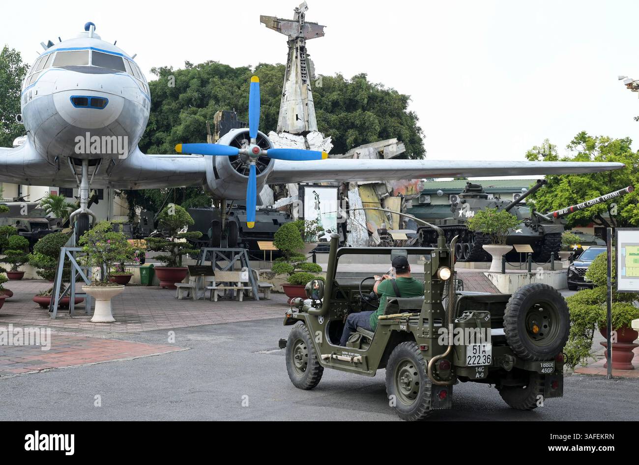VIETNAM, Hanoi, Museo militare, equipaggiamento militare e rottami di guerra della guerra coloniale francese del 1946-1954 e della guerra americana in Vietnam 1955 – aereo vietnamita e jeep dell'esercito americano per tour turistici / VIETNAM, Hanoi, Museo Militär, Ausstellung mit Waffen zum Krieg der Amerikaner in Vietnam, amerikanischer Jeep für Touristen Rundfahrten Foto Stock
