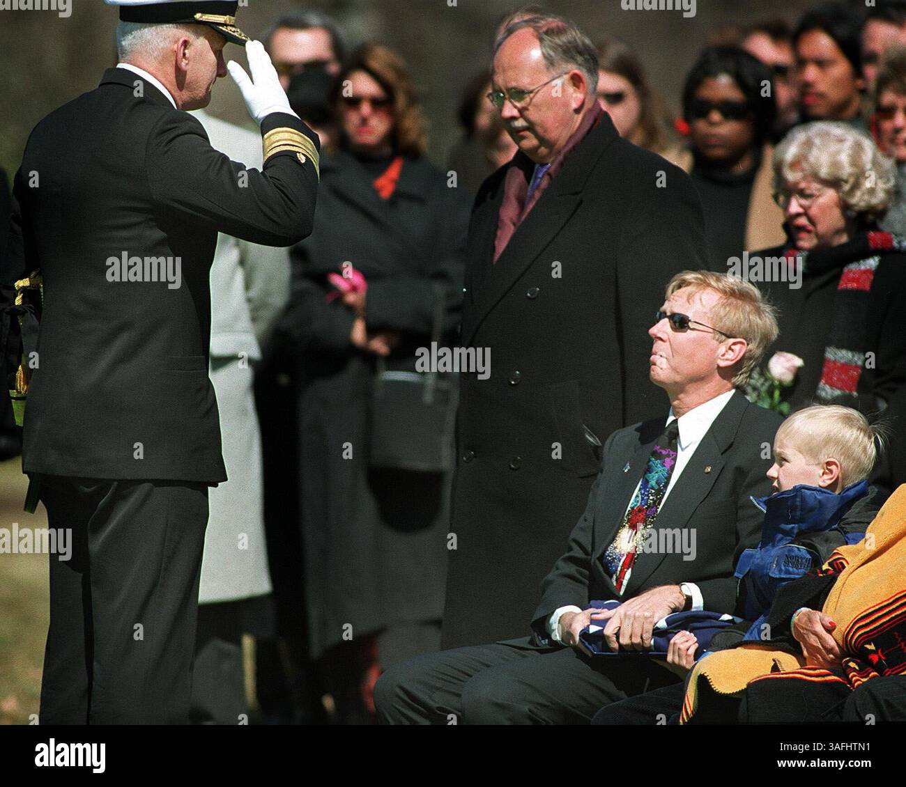 Jon Clark, marito dell'astronauta della Colombia Space Shuttle Laurel Clark, e il figlio Ian, 8 anni, tengono una bandiera piegata durante il funerale del capitano Laurel Clark al cimitero nazionale di Arlington il 10 marzo 2003. Il capitano Laurel Clark e altri sei astronauti della Columbia furono uccisi pochi minuti prima dell'atterraggio, il 1 febbraio 2003. (Immagine di credito: The Washington Times/ZUMAPRESS.com) Foto Stock