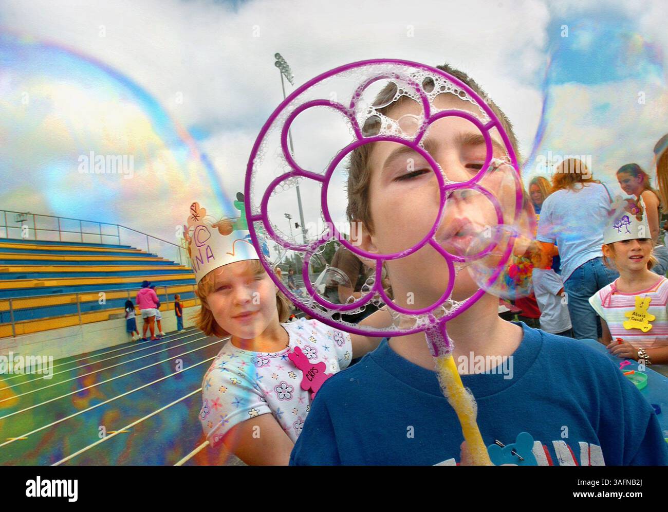 DIDASCALIA: (05/06/2005, CRYSTAL RIVER) Kindergartener Robert Futch (cq), 6, soffia bolle con altri bambini della Crystal River Primary School, tra cui l'asilo Jenna Schubert (cq), a sinistra, durante l'Academy of Health Careers della Crystal River High School, il Kindergarten Field Day annuale, che si tiene presso la pista della scuola superiore di Crystal River venerdì (05/06/2005) mattina. Salute carriere gli studenti dell'accademia hanno collaborato con gli studenti dell'asilo al Crystal River Primary tutto l'anno e hanno un'attività mensile con gli studenti per aiutare ad aumentare la loro consapevolezza su problemi di salute. Il giorno del campo di venerdì era il culo di quest'anno Foto Stock